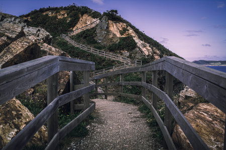 A closeup shot of a fenced pathway on a mountain in Punta pucino do Porco in Lugo, Spain
