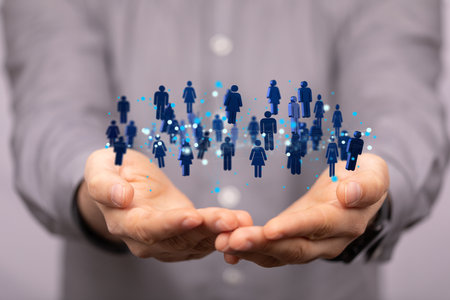 A businessman's hands holding a connected network of profile iconsの写真素材