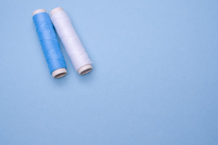 A closeup of threads on the aesthetic blue background.