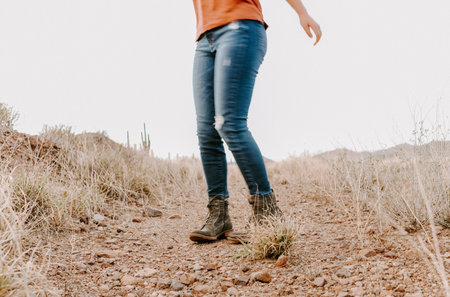 A closeup shot of legs wearing jeans of a young lady in the natureの写真素材