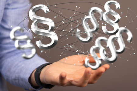 A 3D rendered paragraph symbols on male hand - law and justice concept