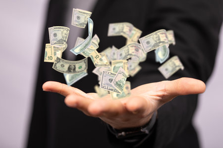 A businessman holding a 3D render of floating dollar banknotesの写真素材