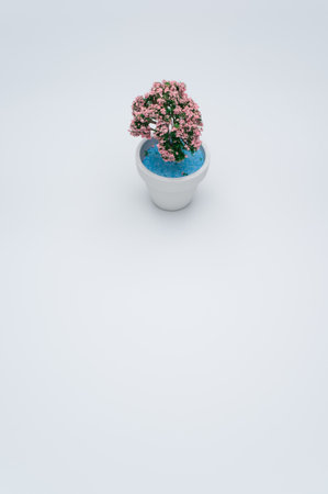 A vertical closeup of an artificial plant on light gray background.の写真素材