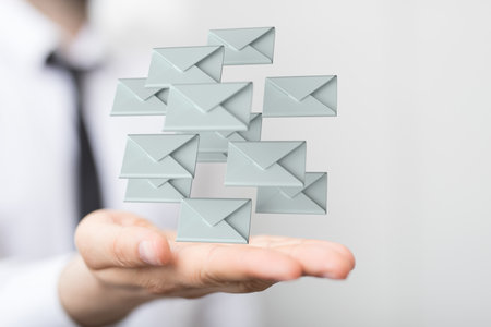 A digital concept of email marketing with floating signs of letters on a handの写真素材