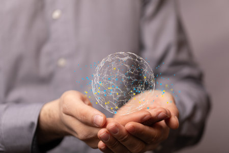 A businessman holding a digital illustration of an interconnected network of lines forming a globeの写真素材