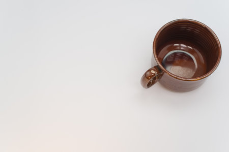 A high angle shot of a brown mug isolated on a white backgroundの写真素材