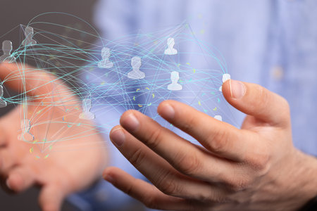 A 3D rendered people silhouettes in the network team held in person's palmの写真素材