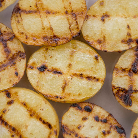 In the picture, we see grilled potatoes, laid down on a surface.の写真素材