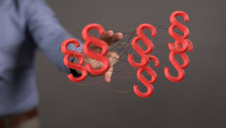 A 3D render of floating paragraph law and justice symbols near a lawyer's hand