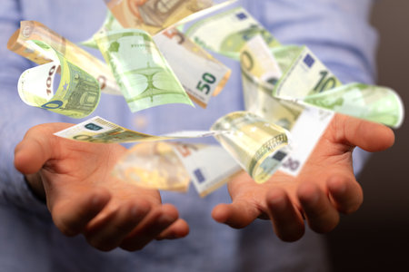 A person holding a 3D render of floating euro banknotesの写真素材