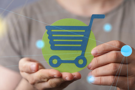 A 3D rendered shopping cart held in a person's handの写真素材