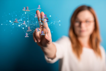 A female touching a 3d rendered network of profile icons - digital network conceptの写真素材