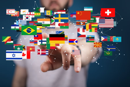 A hand selecting from an interconnected network of international flagsの写真素材
