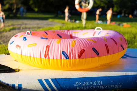 An inflatable donut swimming ring on the house lawnの写真素材
