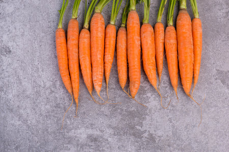 Fresh carrots, vegan food, organic vegetables on a textured backgroundの写真素材
