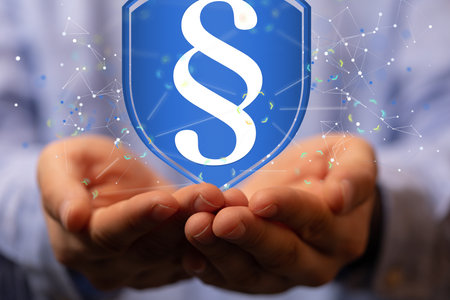 A digital render of a blue shield with a law and justice paragraph symbol