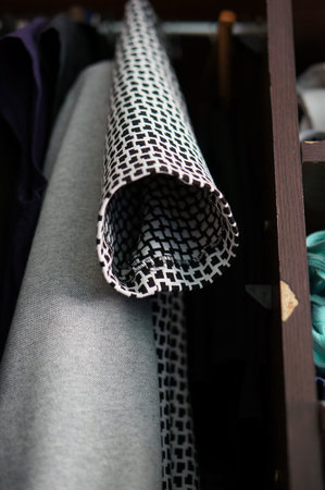 A piece of black and white  clothes on the closet