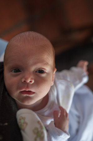 A shallow focus vertical shot of a newborn baby