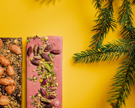 A closeup of chocolate assortment bars with different flavors on a yellow surface