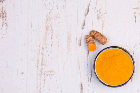 Curcuma spice, fresh roots and powder,empty copy space for text, textured background,isolatedの写真素材