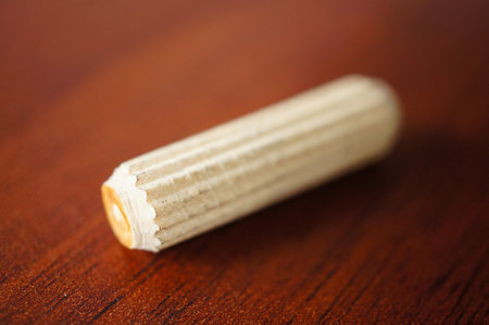 A closeup shot of a wooden pin on a wooden surfaceの写真素材