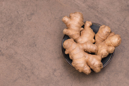 Fresh ginger roots, spice on textured background, empty copy space for textの写真素材