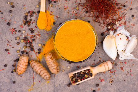 Mix of different spices on a textured background, curcuma, garlic,chilli, pepper cornの写真素材