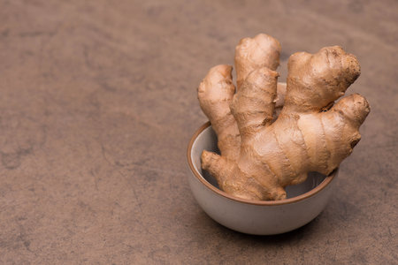 Fresh ginger roots, spice on textured background, empty copy space for textの写真素材
