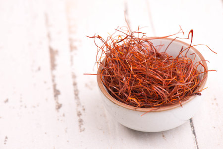 A closeup of chilli threads in a bowl on a white shabby backgroundの写真素材