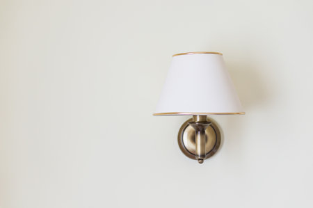 A white contemporary lamp hanging on the wallの写真素材
