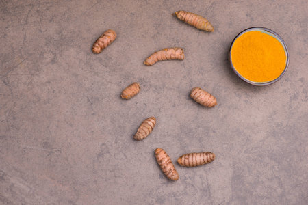 Curcuma spice, fresh roots and powder,empty copy space for text, textured background,isolatedの写真素材