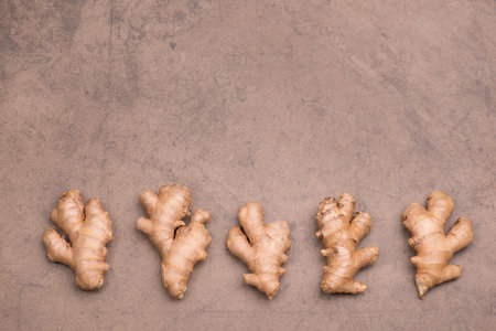 Fresh ginger roots, spice on textured background, empty copy space for textの写真素材