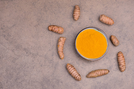 Curcuma spice, fresh roots and powder,empty copy space for text, textured background,isolatedの写真素材