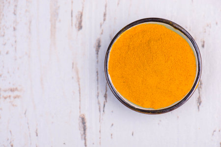 Curcuma spice, fresh roots and powder,empty copy space for text, textured background,isolatedの写真素材