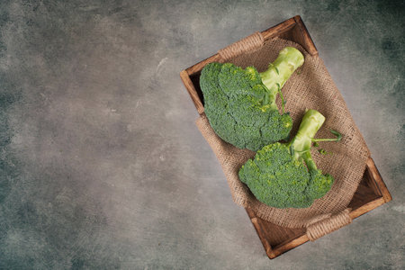 Fresh broccoli on a textured background, empty space for text, vegan foodの写真素材