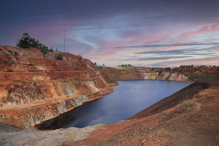 Pond with contaminated waters of an old mine at the sunsetの写真素材