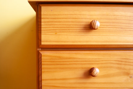 A close-up shot of a modern wooden comfortable bedside tableの写真素材