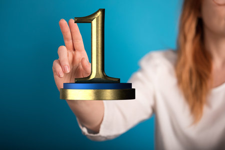 A man holding the 3D first place prize trophyの写真素材