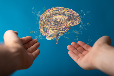 A 3D rendering of a floating human brain above handsの写真素材