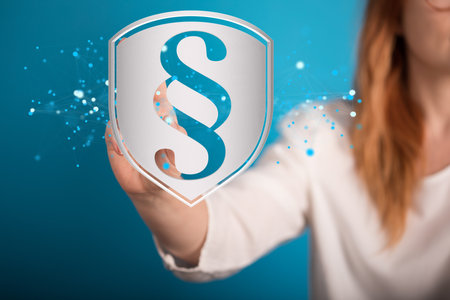 A closeup of a 3D rendered justice symbol with a woman pointing at it in the background.