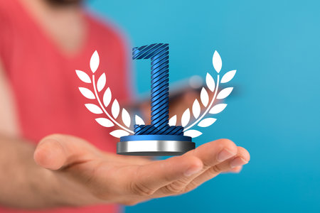 A closeup of 3D rendered number one in a woman's hand - winner, first place conceptの写真素材