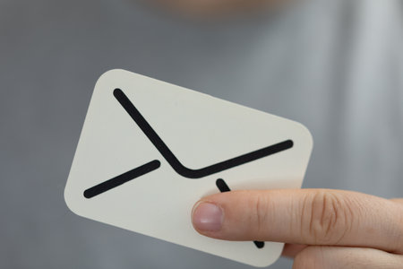 A concept of mailing and  communication, hand holding a  digital paper envelope