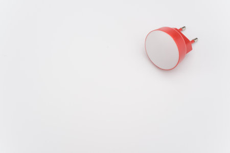 A high angle shot of a l with a plug on a white surfaceの写真素材