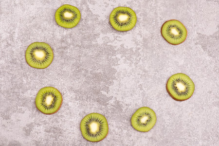 Fresh kiwi on a textured background, empty copy space for text, vegan foodの写真素材