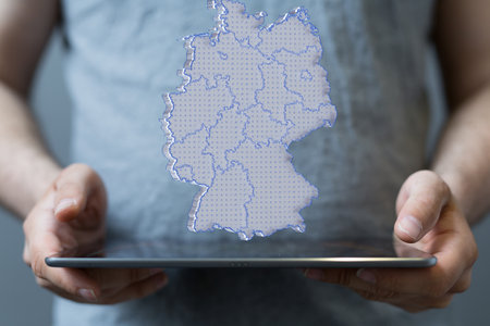 A person presenting a 3D render of the map of Germanyの写真素材