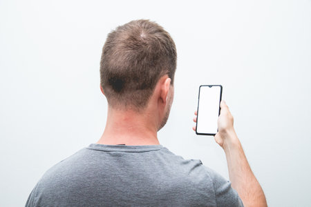 A closeup shot of a handsome man with a smartphone