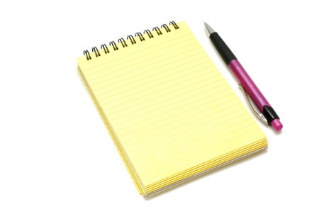 Yellow block with a pen isolated on a white background, empty paper for notes