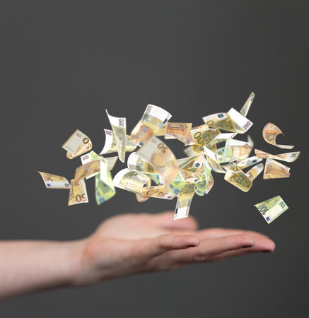 A closeup of a 3D rendering of Euro banknote on a man's hand isolated on a gray backgroundの写真素材