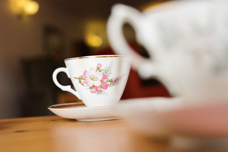 A selective of a beautiful porcelain teacup on a wooden tableの写真素材