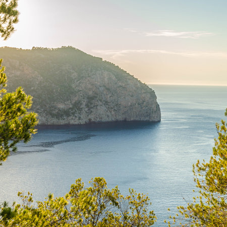 A closeup shot of a beautiful cliff under the sunlight near the blue seaの写真素材
